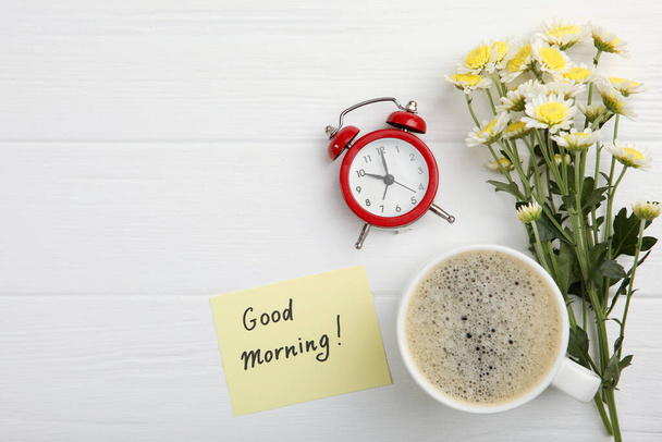A cup of coffee, a bouquet of flowers and a card with the words "good morning". flatlay - Фото, зображення