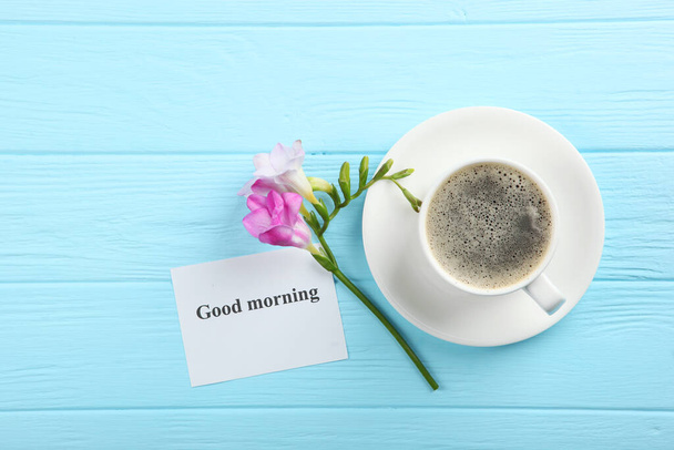 A cup of coffee, a bouquet of flowers and a card with the words "good morning". flatlay - Photo, Image