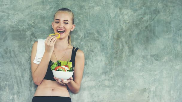 Healthy lifestyle woman fitness gym for body slim. Young people girl hold fresh salad after exercise. Fitness instructor exercising the fitness. Diet and Healthy sport Concept - Fotoğraf, Görsel