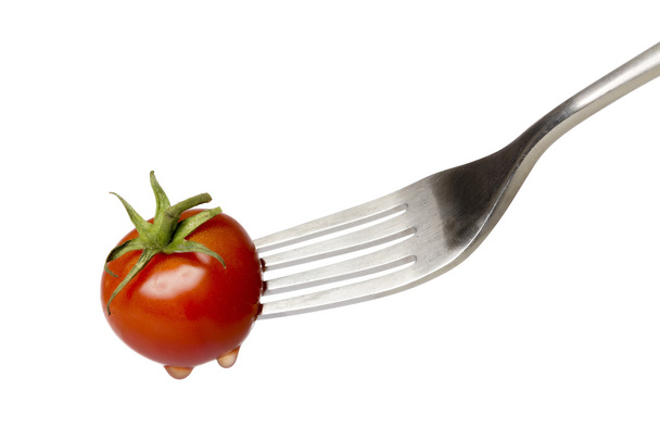 cherry tomato spiked by a fork , isolated on white - Foto, immagini