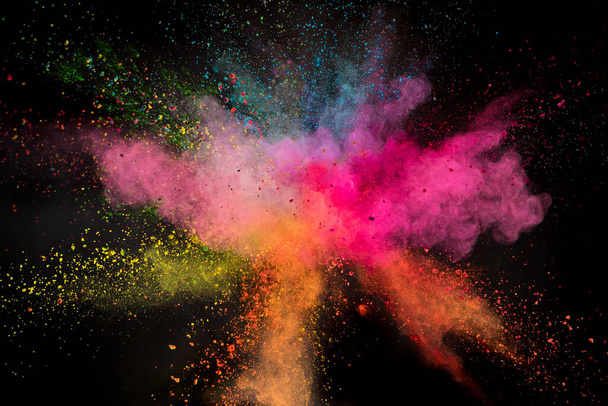 Launched colorful powder on black background - Foto, imagen
