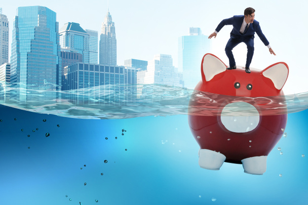 Businessman in debt concept with piggybank - Photo, Image