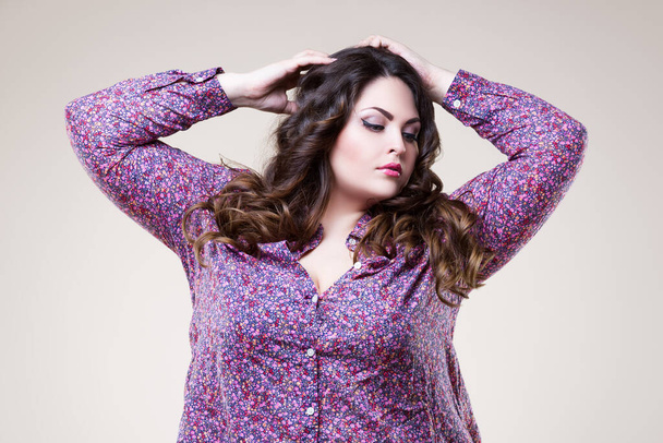 Plus size fashion model with professional makeup and hairstyle, fat woman on beige background, body positive concept - Photo, image