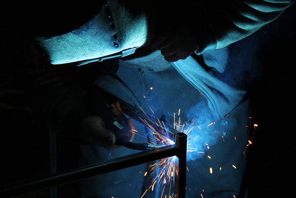 Sparks from welding. A man will weld metal. Workplace of the welder. Garage welder - Fotó, kép