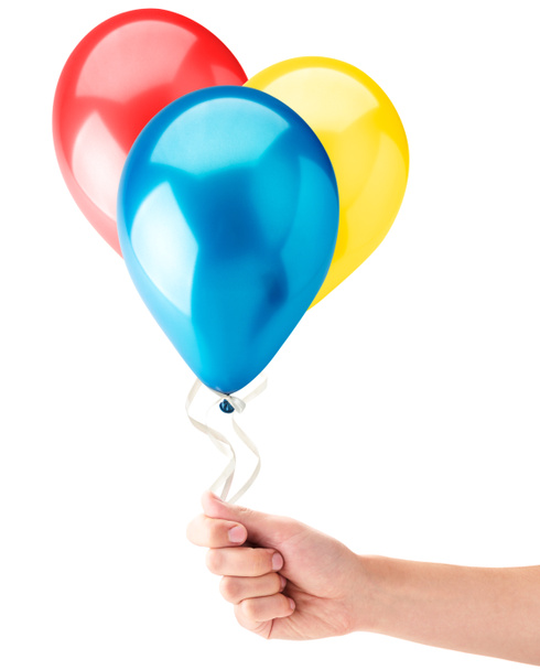 Bolas de helio en una mano sobre un fondo blanco. Aislado
 - Foto, Imagen