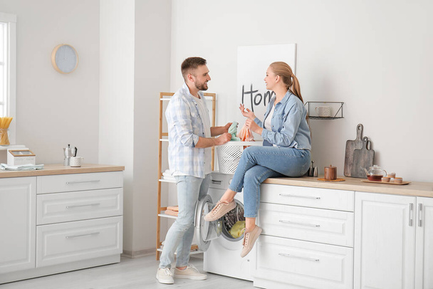 Happy couple doing laundry at home - Photo, Image