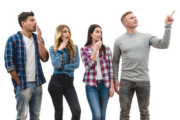 The four surprised people stand on the white background - Photo, Image