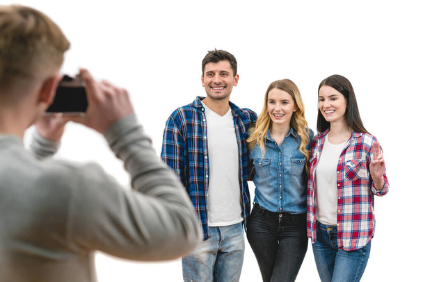 The four friends make a photo on the white background - Photo, Image