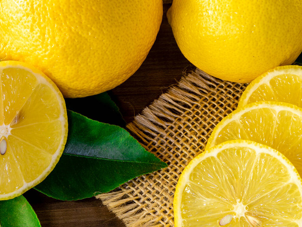 Close up of lemon on wooden background - Foto, afbeelding