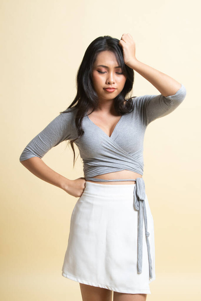 Young Asian woman got sick and  headache   on beige background - Foto, afbeelding