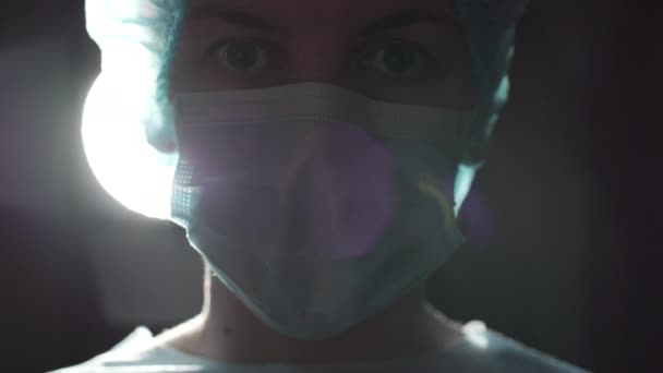 Serious female surgeon wiping forehead, looking at cam, fight for patient's life - Filmagem, Vídeo