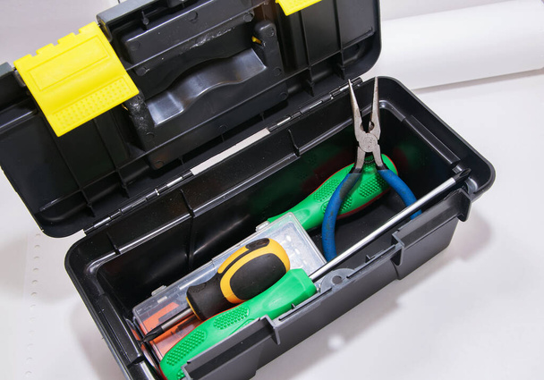 Screwdrivers and pliers are in the gray open tool box, - Foto, Imagem