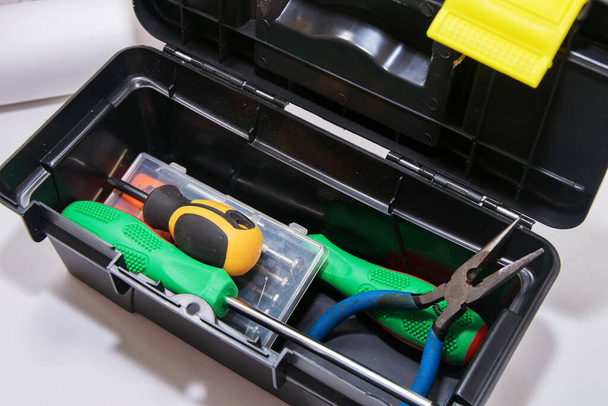 Screwdrivers and pliers are in the gray open tool box, - Foto, afbeelding
