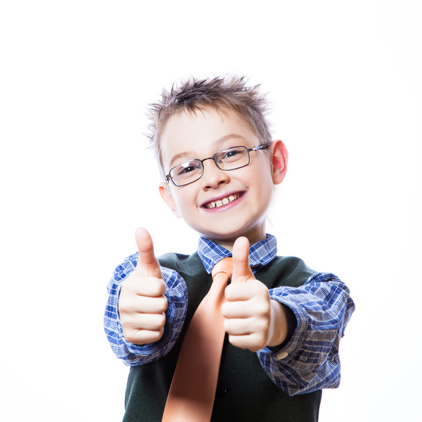 Portrait of happy boy showing thumbs up - 写真・画像