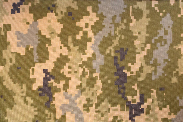 Green pixel camouflage military pattern on textile background - Photo, Image