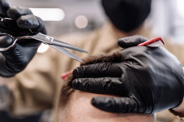 Mens haircut in a barbershop. Styling and hair care.  - Valokuva, kuva