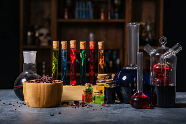 Different potions on table in alchemist's laboratory - Φωτογραφία, εικόνα