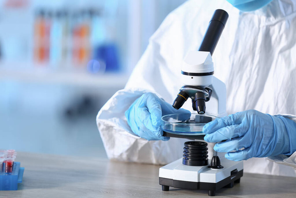 Scientist working with microscope in laboratory - Φωτογραφία, εικόνα
