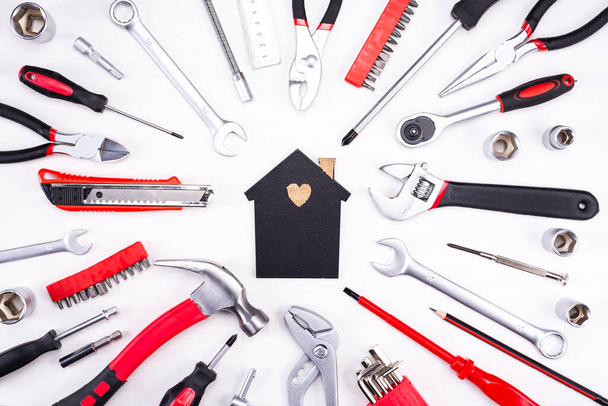 Repair tools as a foundation for a home on a light background. - 写真・画像