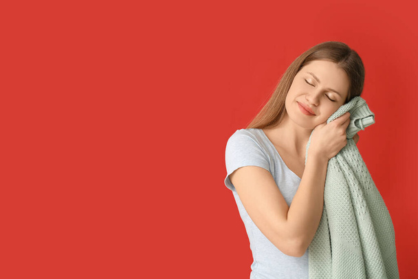 Young woman with clean laundry on color background - Photo, Image