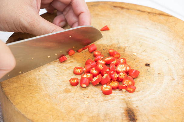 The Sliced red peppers on a wood chopping board - Photo, Image