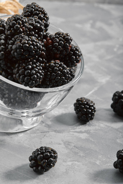 Blackberry on a black background, close-up, fresh berry in a gourd on a concrete background. copies of the space. - Photo, Image