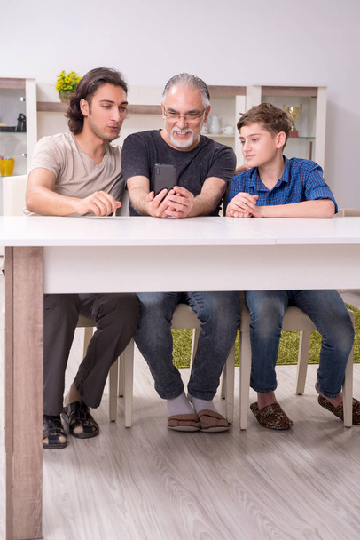 Grandfather learning new technology from son and grandson - Photo, Image