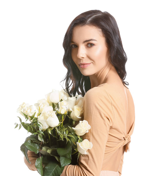Beautiful young woman with bouquet of roses on white background - Photo, Image