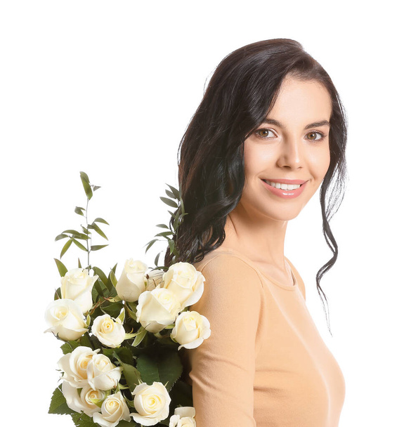 Beautiful young woman with bouquet of roses on white background - Zdjęcie, obraz