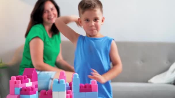 A naughty child in a family throws cubes in which he played. An indifferent mother watches as child behaves badly by offending others by throwing objects at them. June 2019.Kiev, Ukraine. Prores 422 - Materiaali, video