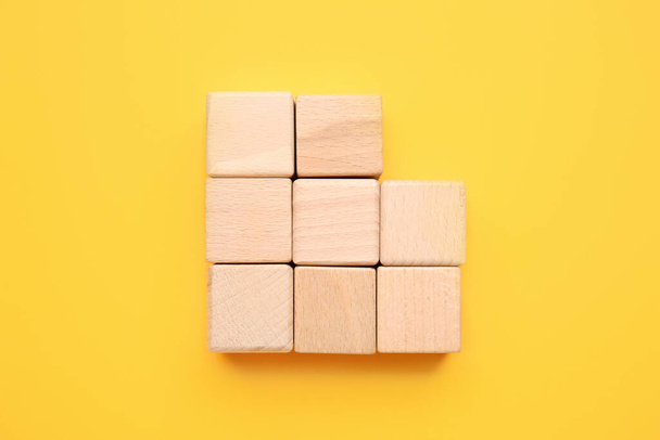 Wooden cubes on color background. Unity concept - Fotografie, Obrázek
