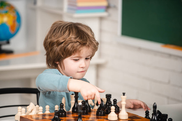 Games and activities for children. Family concept. Boy think or plan about chess game, vintage style for education concept. Kid playing chess in the room. - Φωτογραφία, εικόνα