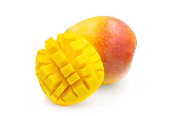 Whole ripe R2E2 mango and slice in cube shape so juicy and fresh on white isolated background with clipping path. Fresh mango have fiber and sweet taste. Excotic tropical fruit for summer refreshing. - Photo, Image