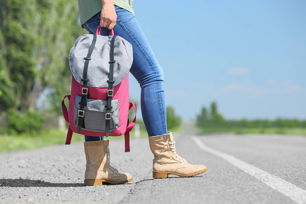 Female traveler with backpack standing on road - Fotografie, Obrázek