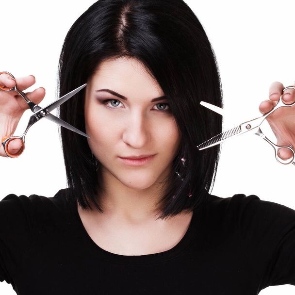 Professional hairdresser with tools posing in studio - Foto, imagen