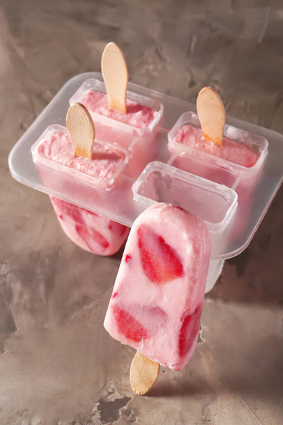 Tasty strawberry ice cream on grunge background - Photo, Image
