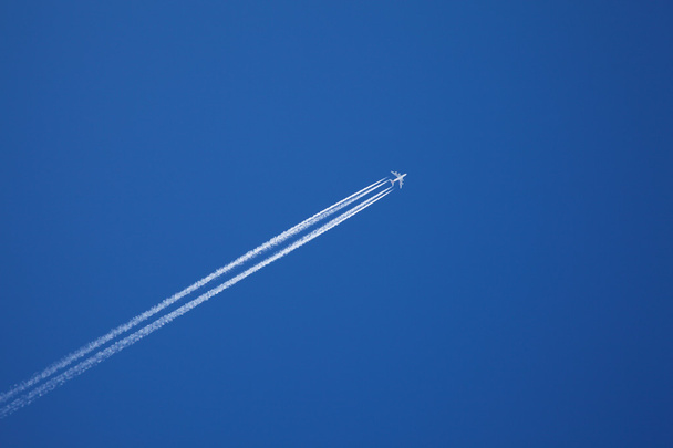 A long trail of jet plane on blue sky - Photo, Image