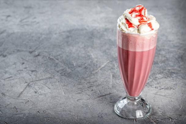 Cherry milkshake in a transparent, tall, glass glass. Close-up shot - Photo, image