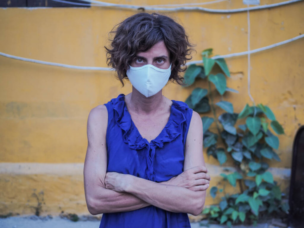 woman wearing protective mask and blue dress, coronavirus pandemic and quarantine concept - Φωτογραφία, εικόνα