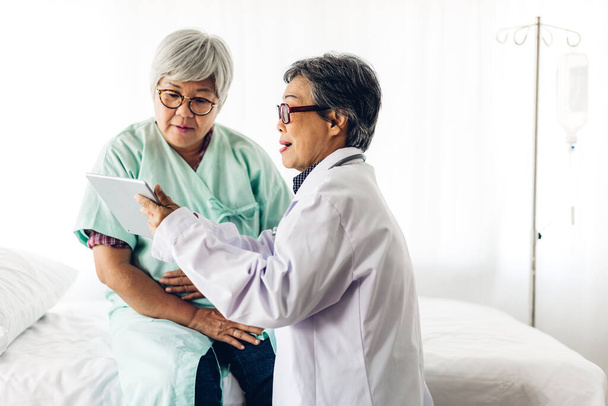 Doctor consulting and check up information with senior woman in hospital.elderly woman has sick.healthcare and medicine - 写真・画像