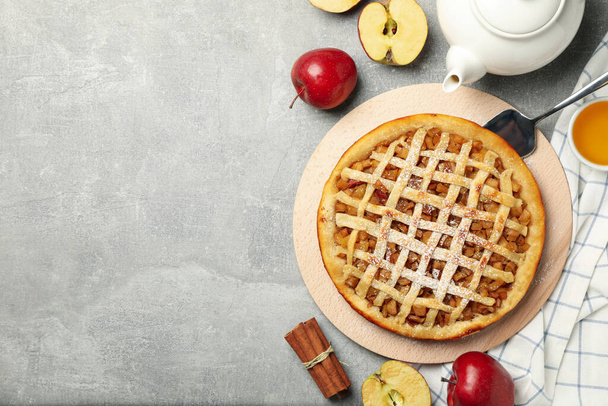 Composition with apple pie and ingredients on gray background, top view - Fotoğraf, Görsel
