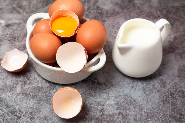 卵と牛乳を灰色の背景でクローズアップし - 写真・画像