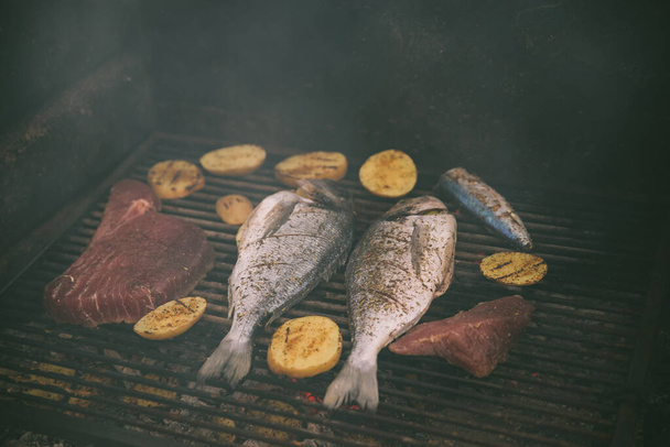 vaření ryb a brambor na grilu venku - Fotografie, Obrázek