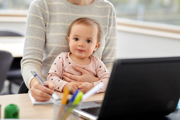 mother with baby working at home office - Photo, image