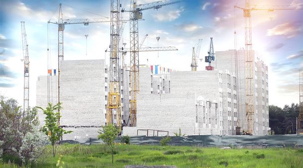 Construction crane and building under construction in the city. Apartments for sale. Housing concept - Photo, Image