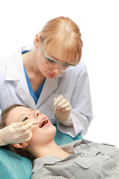 Examining patient's teeth - 写真・画像