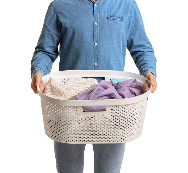 Young man with laundry on white background - Photo, Image