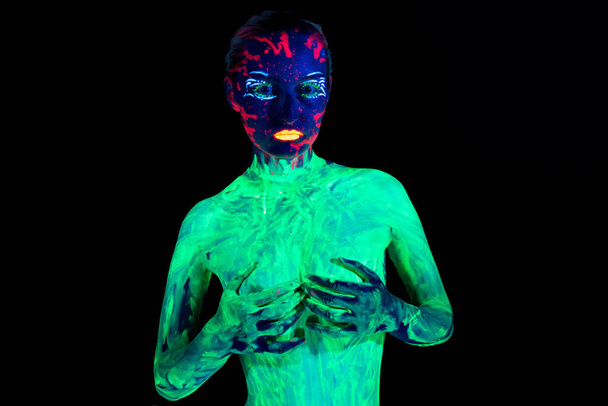 Photo of girl with covered breast in neon - 写真・画像
