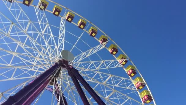Giant Ferris Wheel against blue sky. Low angle view. - Footage, Video