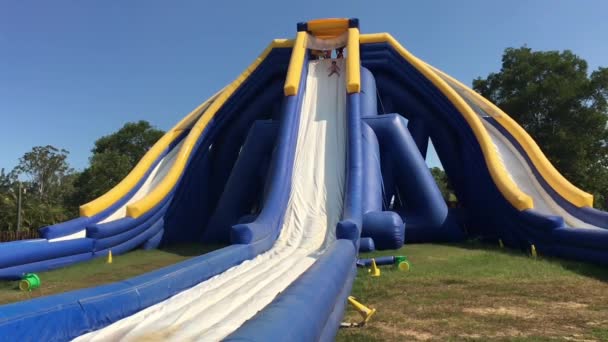 Young girl sliding down from a Giant inflatable slide in Australia Zoo in Sunshine Coast in Queensland, Australia. - Footage, Video